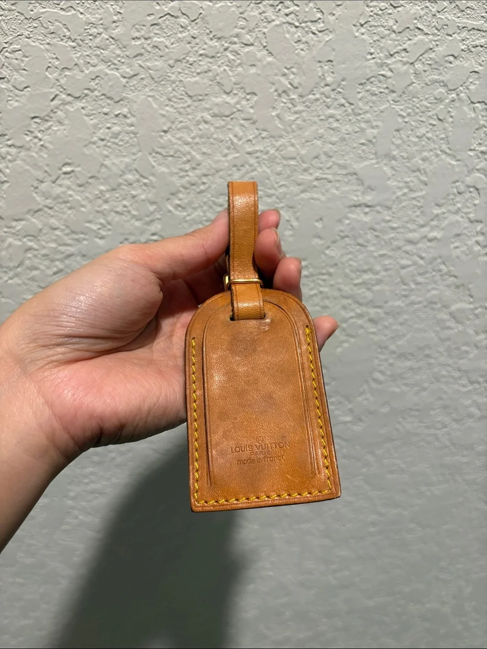 Louis Vuitton leather luggage tag.